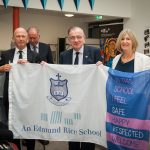 Mr Pat Keating ERST, Br Edmund Garvey, Christian Brothers and Ms Patricia McCrossan, with the Colaiste Choilm Flag